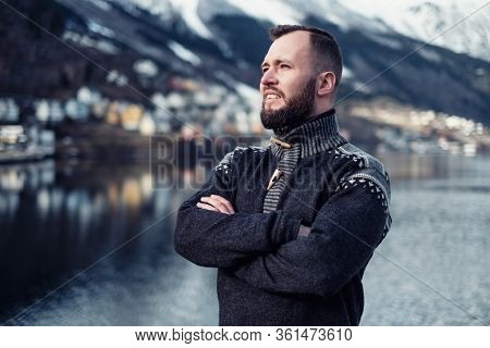 Man in front of beautiful town of Odda, Norway