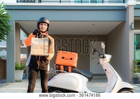 Delivery Asian Man Wearing Orange Uniform And Ready To Send Delivering Food Bag In Front Of Customer