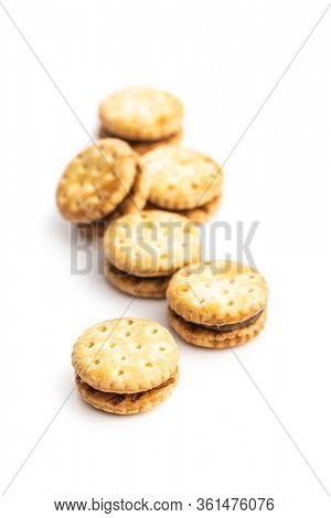 Mini cream sandwich cookies isolated on white background.
