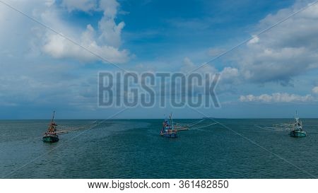 Three Traditional Thai Fishing Boats With Outriggers Out Near Pythiu On The Gulf Of Thailand