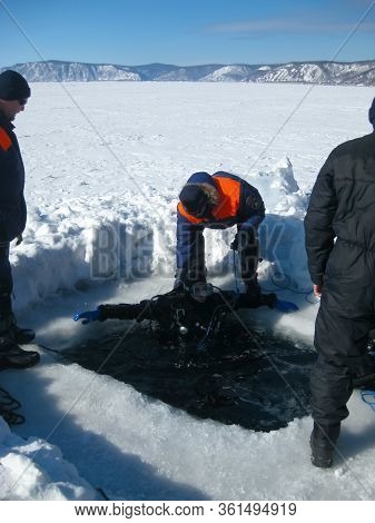 Lake Baikal, Russia - March 12, 2020: Rescue Divers Conduct Training Camps On Lake Baikal. Divers In