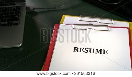 Closeup Of Resume On Clipboard On Top  Of Office Table