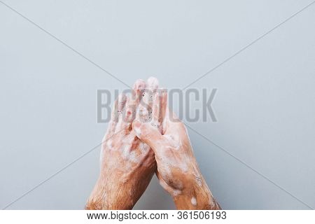 Man Cleaning His Hands Using Liquid Disinfectant Soap.