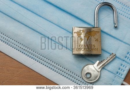 Coronavirus World Lockdown End: An Open Lock With A World Map And The Word Lockdown Engraved And A K