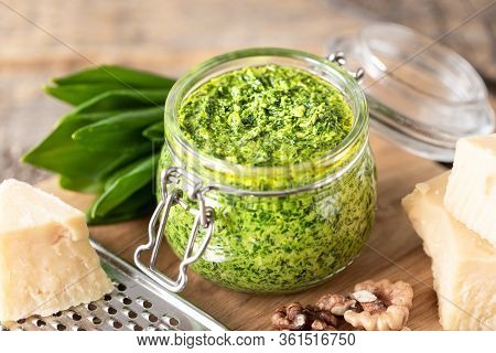 Wild Leek Pesto With Olive Oil And Parmesan Cheese In A Glass Jar On A Wooden Table. Useful Properti