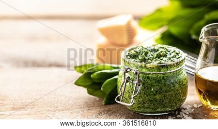 Wild Leek Pesto With Olive Oil And Parmesan Cheese In A Glass Jar On A Wooden Table. Useful Properti