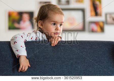 Two Year Old Girl With Big Eyas Portrait Looking Right With Copy Space On Right, Indoor Shoot With N