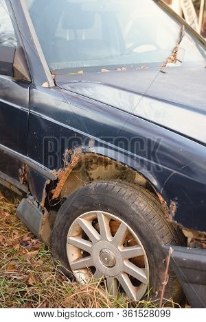 Old Broken, Rusty Car. Car After The Accident Rots Abandoned In The Wasteland.