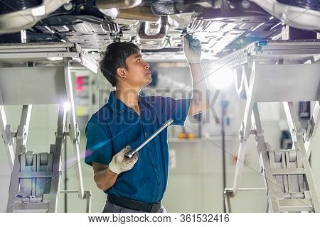 Closeup Asian Mechanic Hand Repairing Under The Car In Maintainance  Service Center Which Is A Part 