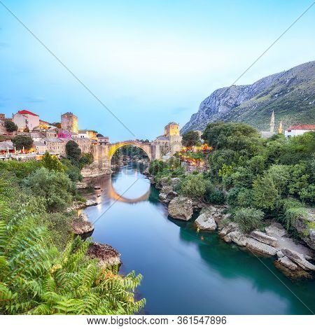 Majestic Evening View Of Mostar With The Mostar Bridge, Houses And Minarets, At Evening. Location: M