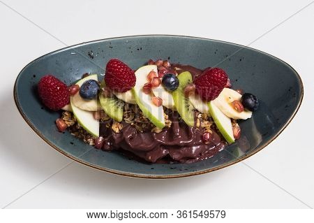 Acai Cerry Smoothie Bowl Topped With Raspberries, Bananas And Blueberries