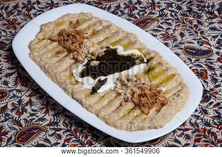 Homemade Iranian Hummus With Oil On A White Plate.