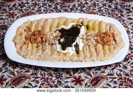 Homemade Iranian Hummus With Oil On A White Plate.