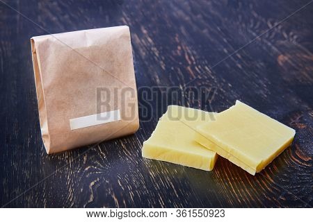 Handmade Soap Bars On Wooden Board. Mock Up Eco Paper Packaging For Soap. Craft Natural Soap On Wood
