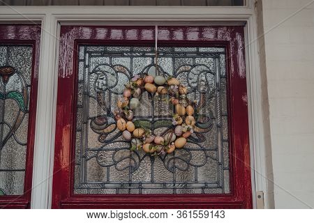 Close Up Of An Easter Egg Wreath On A Stained Glass Door Of An Edwardian House In London, Uk.