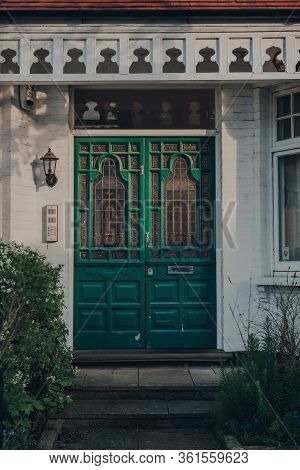 London, Uk - April 12, 2020: Stained Glass Bright Green Wooden Door Of A Traditional Edwardian House