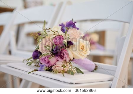Bridesmaid Flower Arraignment On White Ceremony Chair Outdoors