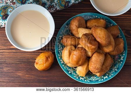 National Cuisine - Uzbek Baursaki In A Plate With A Traditional Pattern, On A Dark Wooden Table. Bas