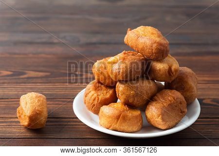 National Cuisine - Uzbek Baursaki In A Plate On A Dark Wooden Table. Bashkir Cuisine, Kazakh Cuisine