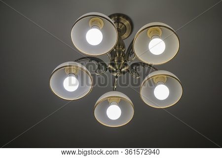 5-light Chandelier Hangs On The White Ceiling