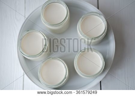 Homemade Organic Yogurt In Glass Jars In Yogurt Maker. Automatic Yogurt Machine To Make Fermented Mi