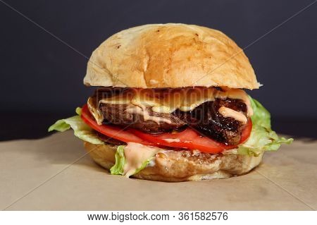 Juicy Burger With Chicken And Lamb Meat On A Dark Background
