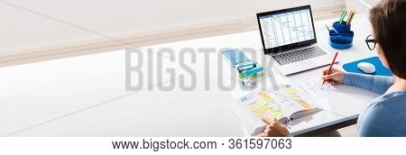 Person Marking Business Calendar Schedule In Office