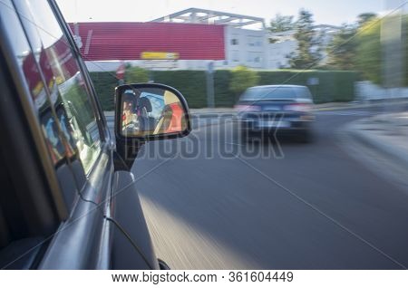 Driving Fast At Urban Areas. Motion Blurred Shot