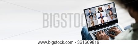 Man Working From Home Having Online Group Videoconference On Laptop