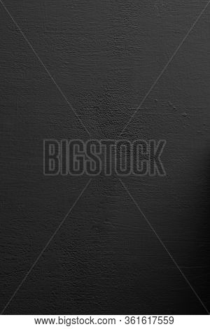 closeup of a rustic black plastered wall to be used as a background