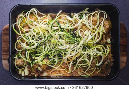 Healthy Plant-based Food,  Vegan Potato Bake With Spicy Sauce And Zucchini Noodles Topping Before Go