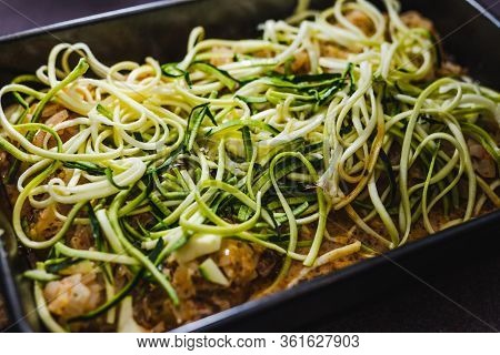 Healthy Plant-based Food,  Vegan Potato Bake With Spicy Sauce And Zucchini Noodles Topping Before Go