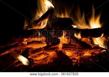 Burning Wood Logs In The Fireplace Close Up. Barbeque Fire. Charcoal And Burning Wood Background. Fi