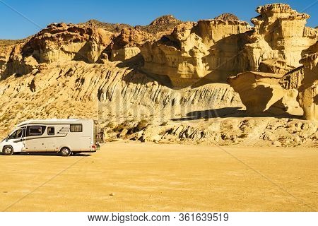 Bolnuevo, Spain - March 15, 2019: Camper Car On Parking Area At Eroded Yellow Sandstone Formations, 
