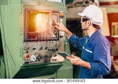 Factory Worker Man Operate The Machine, High Skill Labor Work Industry With Safety Clothes.