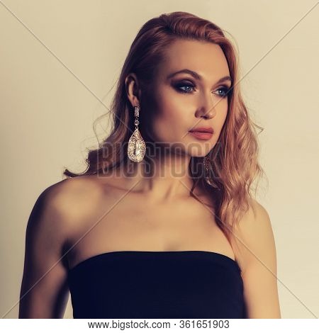 Sensual Portrait Of Very Attractive Blond Woman With Creative Hair Style And Big Fashion Earring Wit