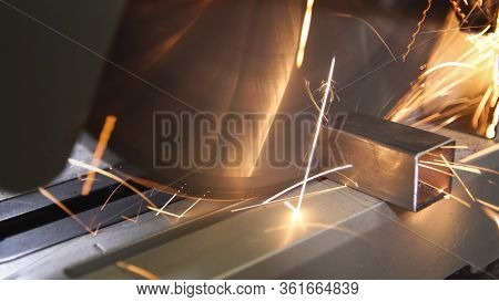 Iron Sawing Close Up. Hot Sparks At Grinding Metal.