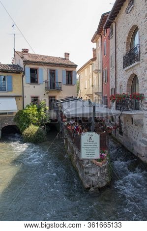 Italy, Valeggio Sul Mincio - May 20 2018: The View Of The River And Restaurant In Borghetto On May 2