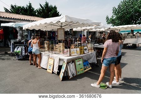 Loix-en-re, France - August 7, 2018: People At Market Stall In The Artisans Market.