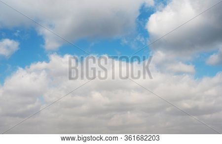 Clouds Swiftly Swim Through The Blue Sky Of The Day