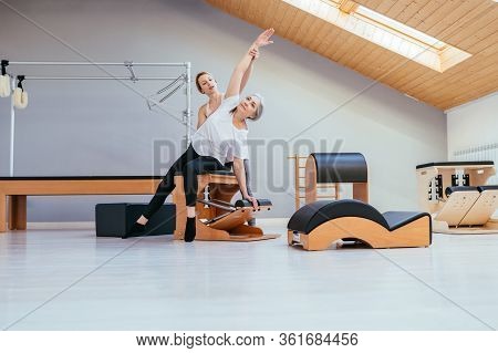 Older Women Doing Pushups. Young Personal Trainer Helping Senior Woman. Workout In Rehabilitation Ce