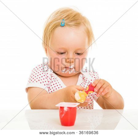 Cute Infant Girl Learining To Eat With Spoon