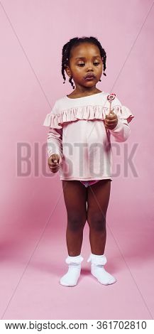 Little Cute African Girl Posing Cheerful Inocent On Pink Background, Lifestyle People Concept