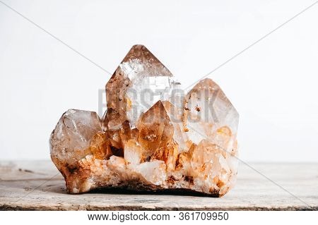 Smoky Quartz Crystal On A Wooden Surface On A White Background. Copy, Empty Space For Text