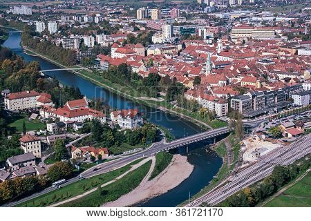 Aerial View To The City Celje In Slovenia. Red Roofs, River And The Bridge. Outdoor Travel Backgroun