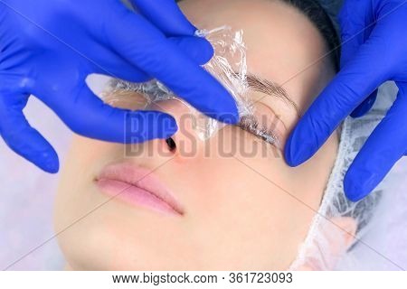 Beautician Revoves File From Woman Lashes, Pads And Towel, Lifting Procedure. Girl With Solution For