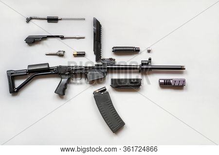 Disassembled Machine Gun On A Gray Background. Isolated. Details Of Firearms In A Disassembled State