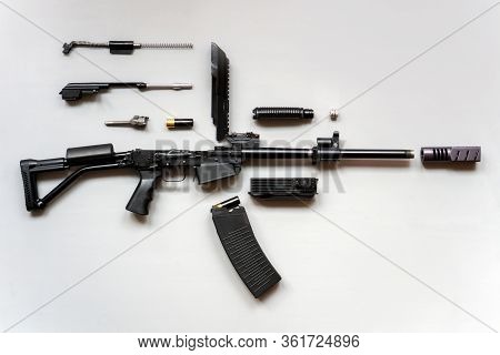 Disassembled Machine Gun On A Gray Background. Isolated. Details Of Firearms In A Disassembled State
