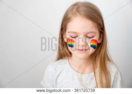 Kid Girl With Blond Hair And Painted Cheeks A Rainbow. Stay Home. Flashmob Chasetherainbow.