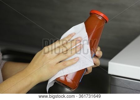 Covid-19 Pandemic Coronavirus Woman Disinfect Bottle Of Tomato Puree With Wet Wipes Cleaning Against